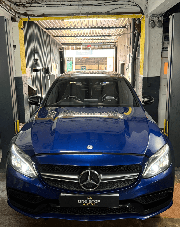 Mechanic inspecting vehicle